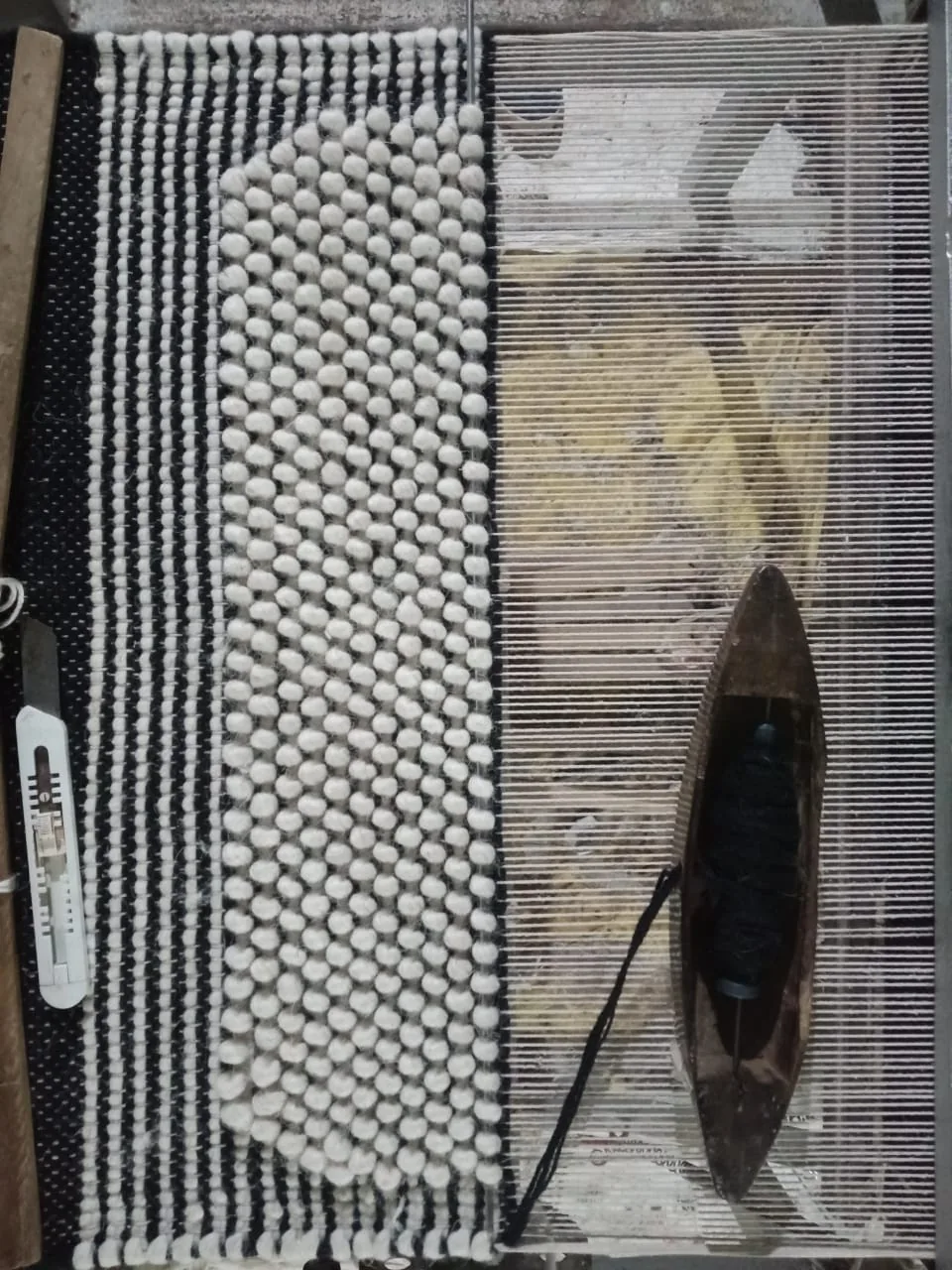 Braided wool rug in progress on the loom