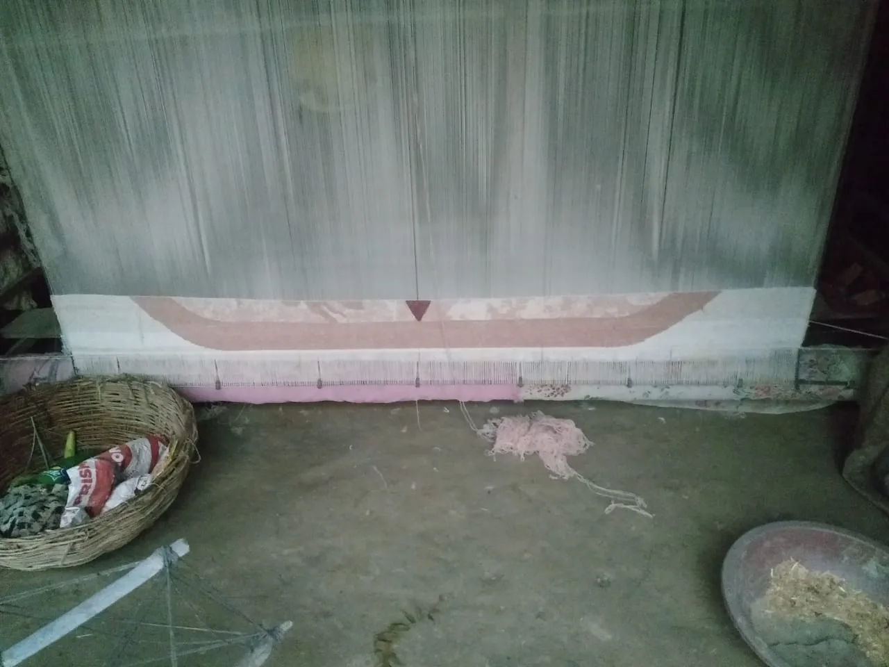 A custom hand-knotted rug in progress on the loom at PiHue, Bhadohi