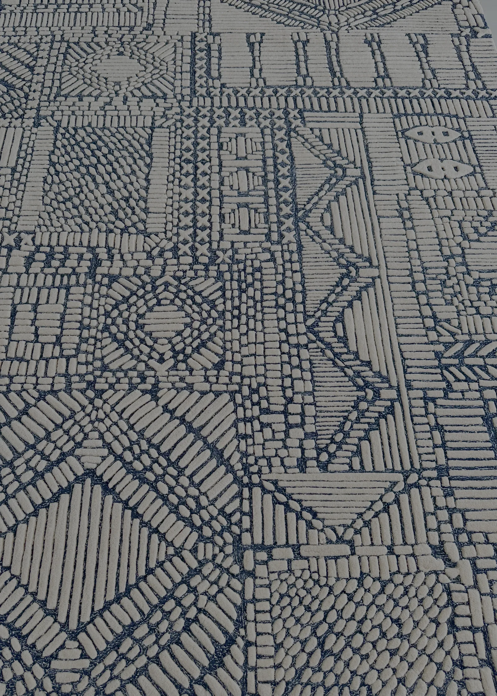 A hand-tufted carved wool rug on the QC bench at PiHue