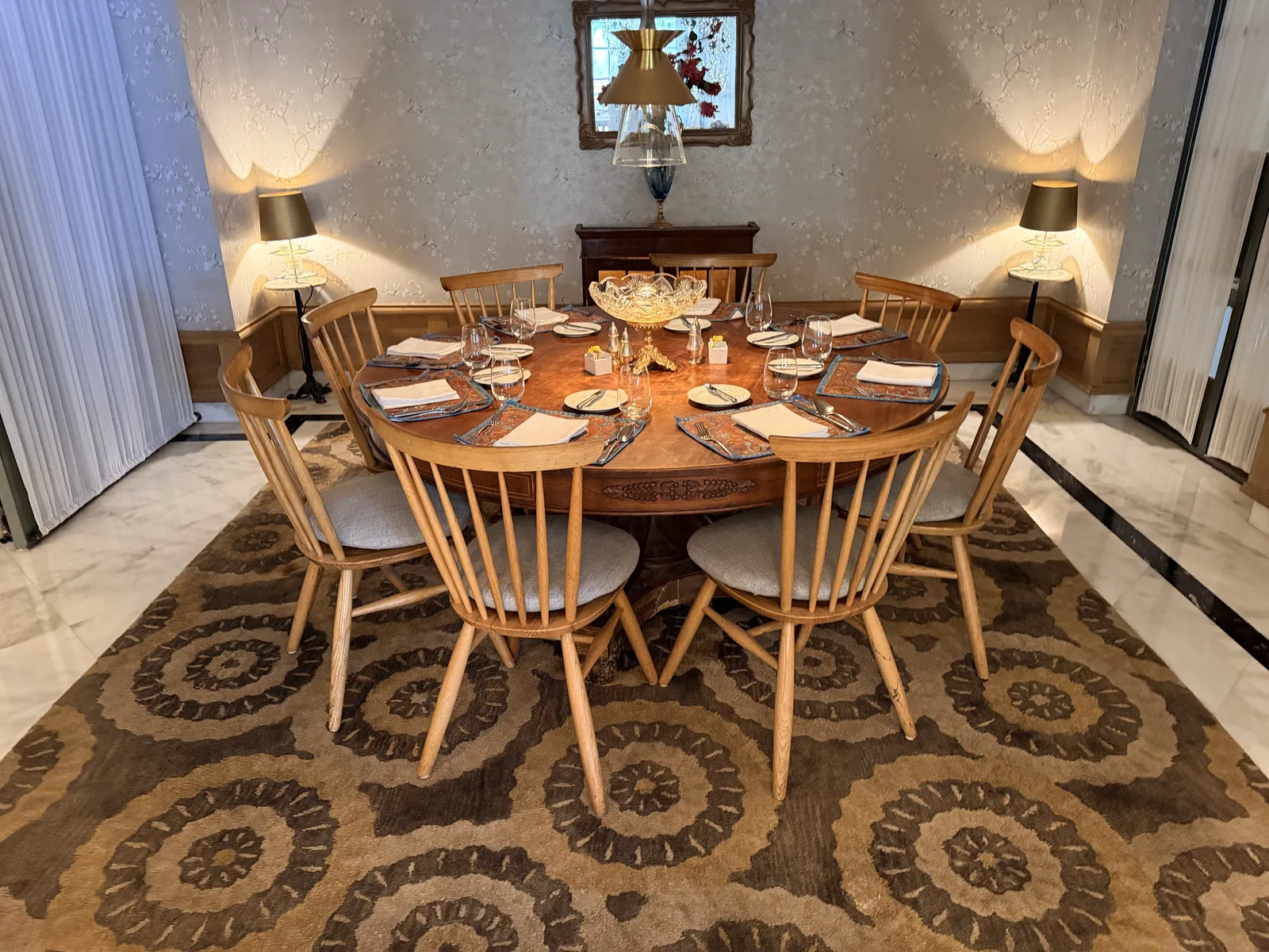 A finished handmade rug installed under a dining table — approved, packed and delivered
