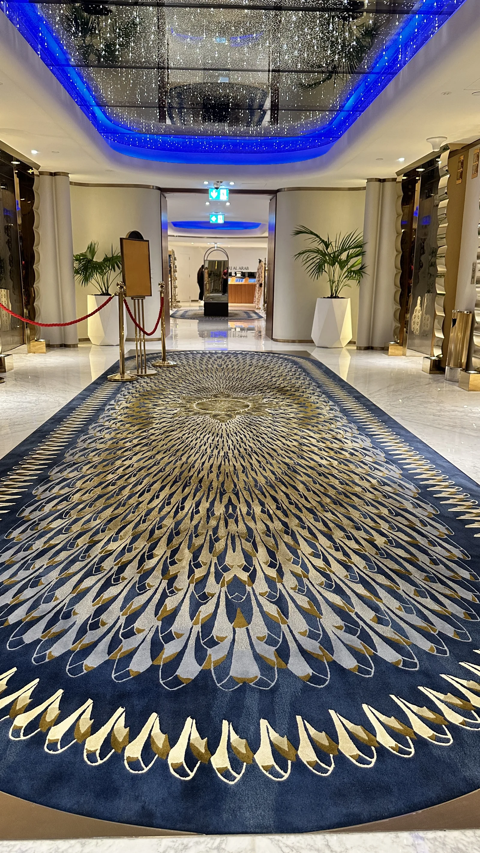 A finished oval hand-knotted rug installed in a hotel setting