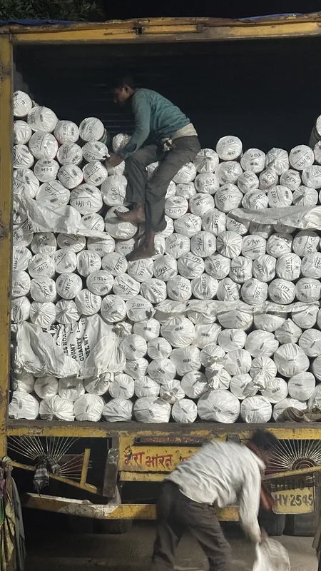 Packed and numbered rugs being loaded into a shipping truck at PiHue Bhadohi