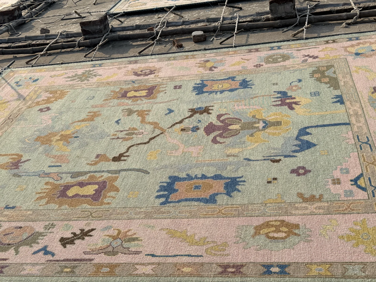 A rug being stretched to true its shape to specified dimensions